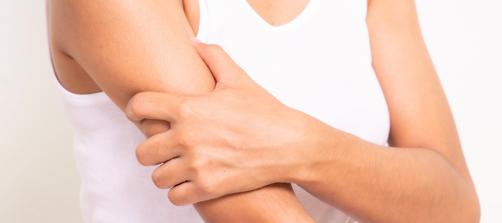 Woman holding her arm because of numbness or tingling