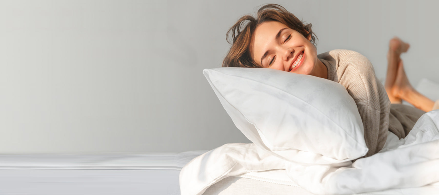 woman smiling in her bed