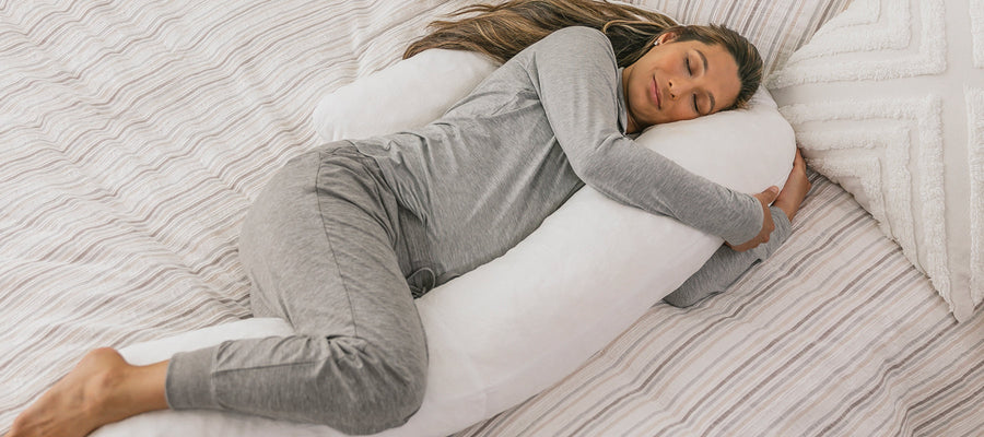 pregnant woman sleeping with her medcline therapeutic body pillow