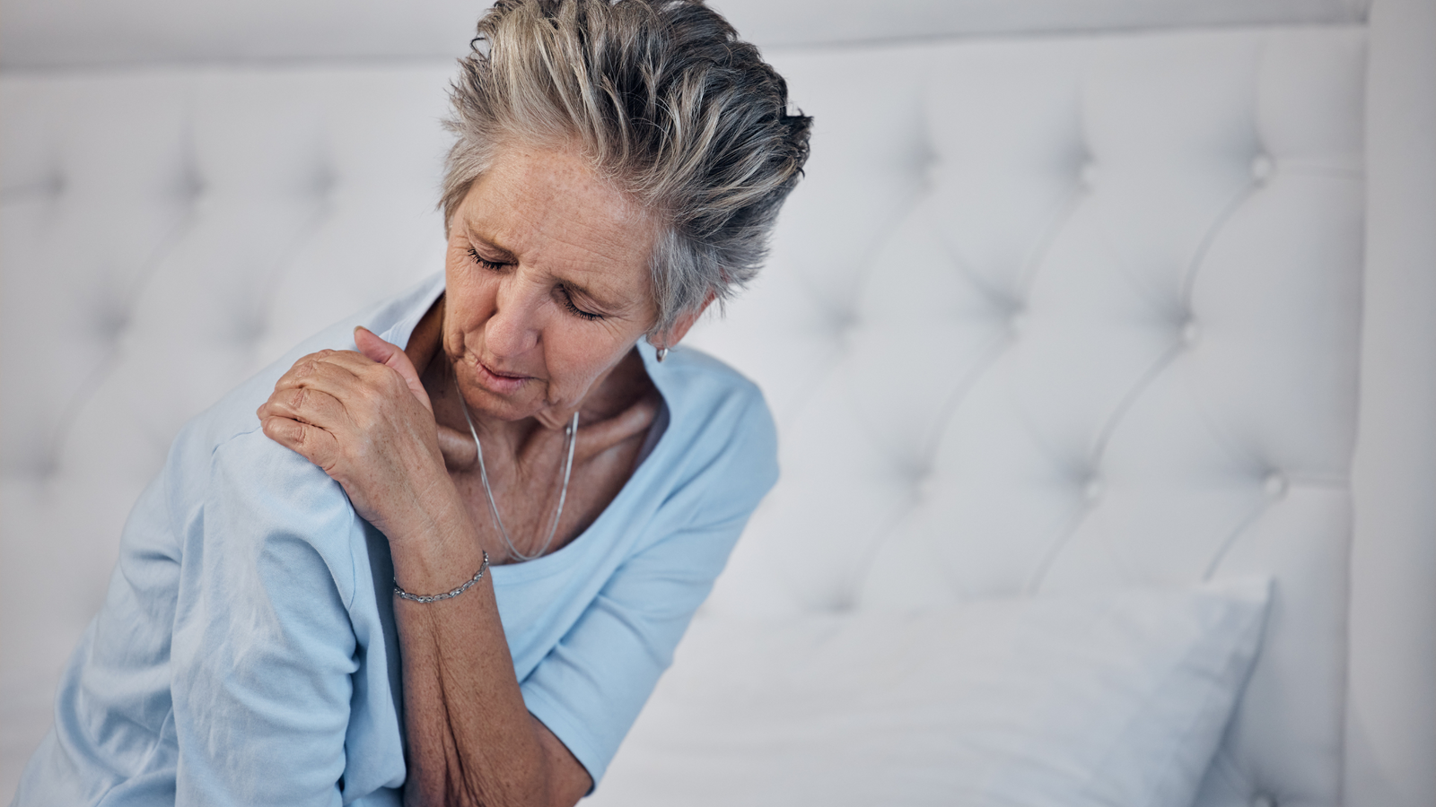 woman suffering from arthritis in her shoulder