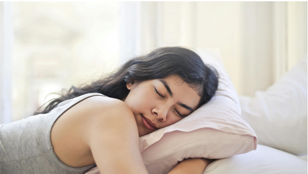 Woman sleeping on her stomach with a comfortable pillow