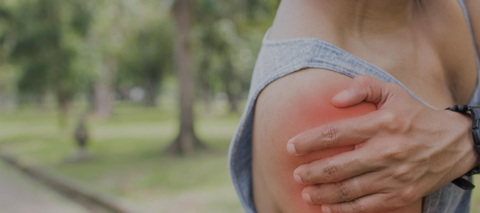 Person holding her shoulder because of pain