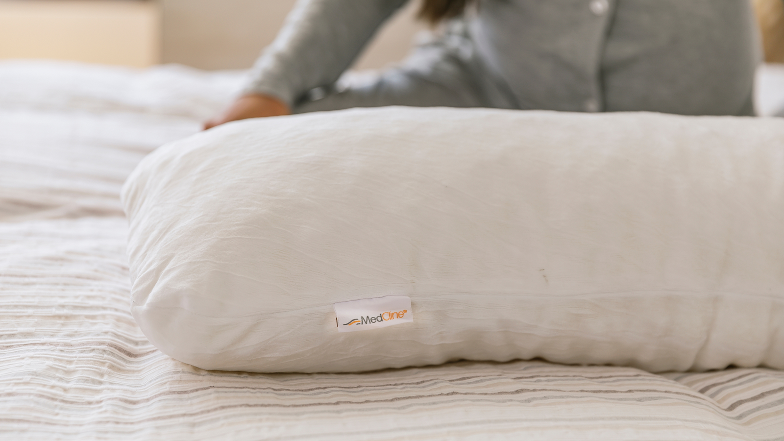 pregnant woman sleeping with a MedCline body pillow