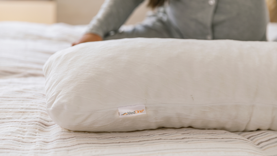 pregnant woman sleeping with a MedCline body pillow