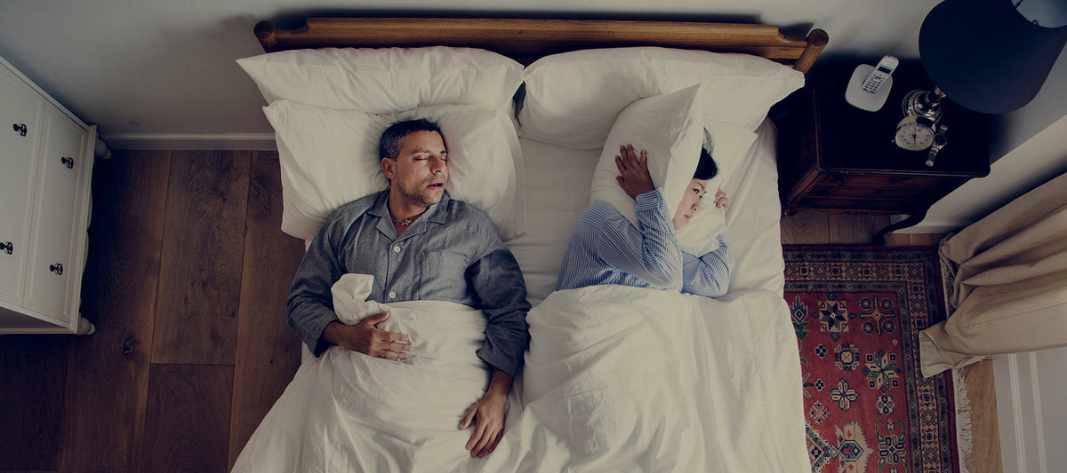 couple arguing in bed because of sleep deprivation