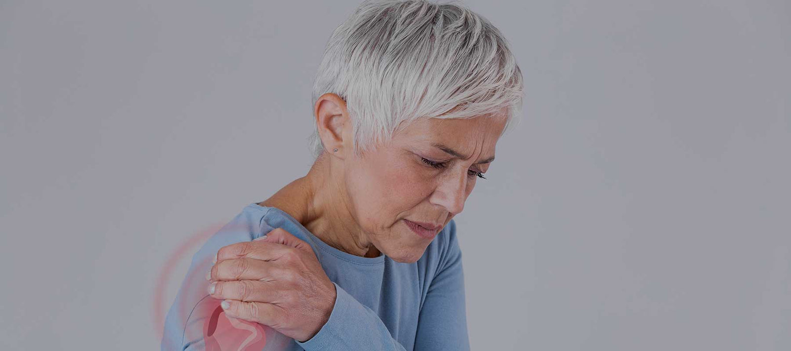 woman holding her shoulder because of pain