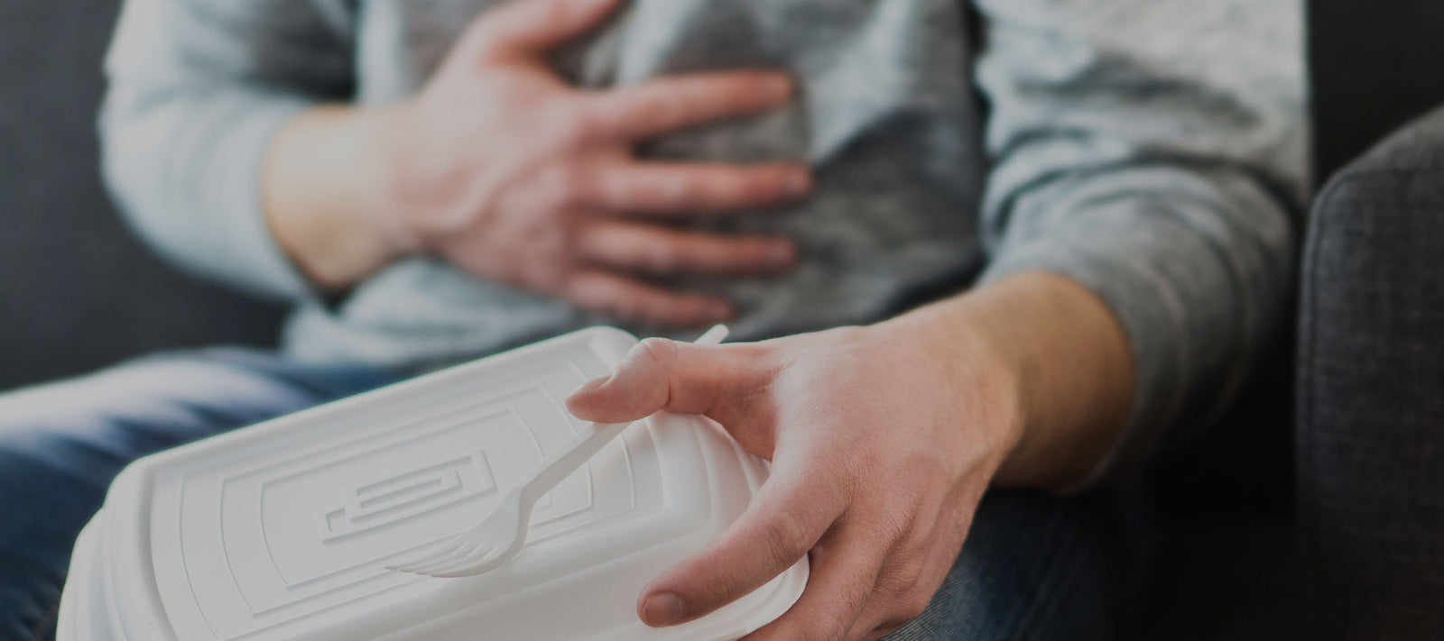 man suffering from acid reflux after eating