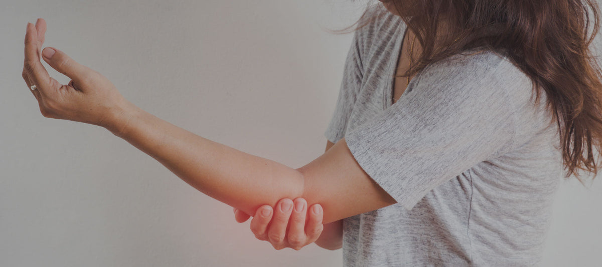 Women suffering from numbness and holding her elbow