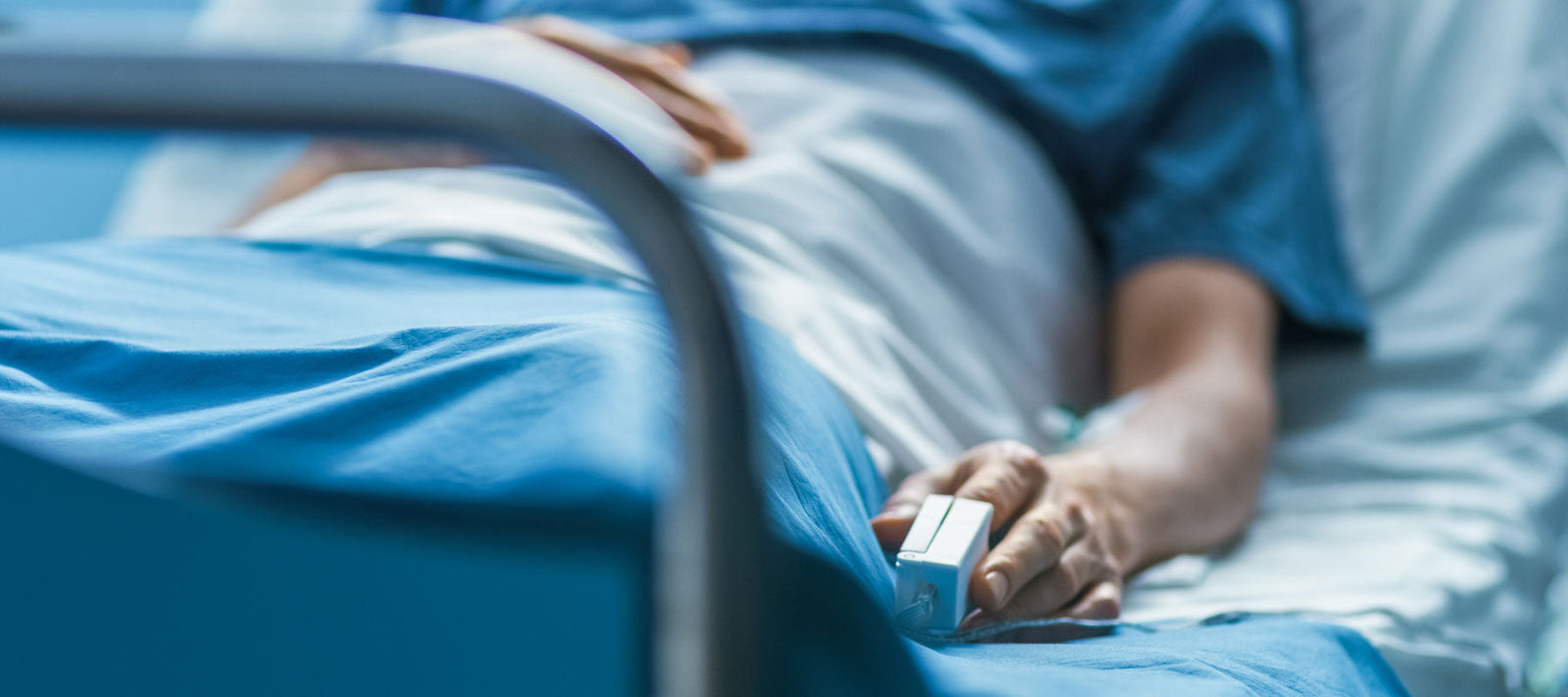 Person in a clinical bed after surgery
