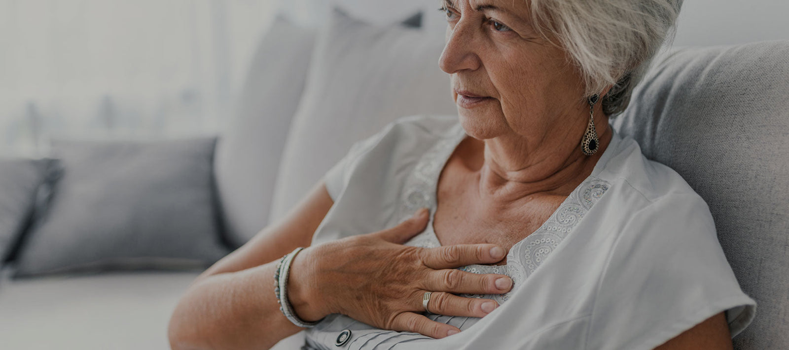 woman holding chest suffering from acid reflux