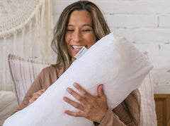 woman holding the therapeutic body pillow